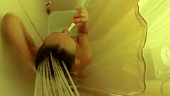 Brett Rossi intensely masturbates in the shower, showcasing her big tits and ass