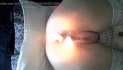 extreme scene with two candles in her body.