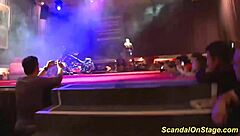 Busty Milf Strips on Stage for Scandalous Group