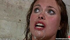 A woman who is tied up as part of a BDSM marriage scene gets a double penetration in the anal sex in the basement