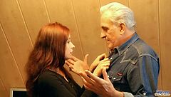 Red-haired woman gives thanks to the elderly man for his help with a sexual experience