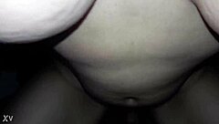 Beautiful housewife enjoying a cold glass of milk while sitting on her stool