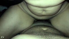 Beautiful housewife enjoying a cold glass of milk while sitting on her stool