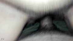 Beautiful housewife enjoying a cold glass of milk while sitting on her stool