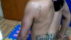 The brunette tattooed girl sits on the console for the first time