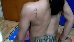 The brunette tattooed girl sits on the console for the first time