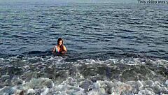 Horny teen shows off her big ass on the public beach, getting her pussy exposed outdoors