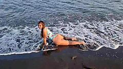 Horny teen shows off her big ass on the public beach, getting her pussy exposed outdoors