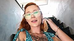 Redhead masturbates with a dildo and squirts on the stairs