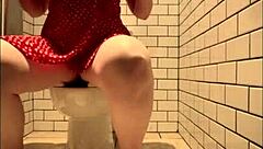 Horny girl satisfies herself in the restaurant restroom