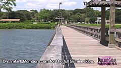 Sophia masturbates her hairless pussy in public pool, showing big tits outdoors.