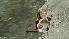 on the beach, an amateur couple engages in passionate sex under the sun