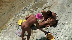 on the beach, an amateur couple engages in passionate sex under the sun