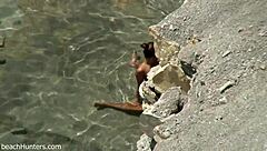 on the beach, an amateur couple engages in passionate sex under the sun
