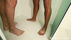 Big black guy bathes and gets blowjob from white guy.
