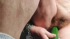 Old woman enjoys a hairy cucumber in her private part