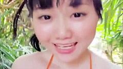 Japanese woman dances sexily with big tits at pool