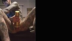 Tattooed guy strokes cock in fleshlight solo