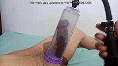 A gay man uses a penis pump while giving a blowjob