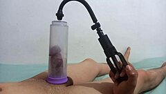 A gay man uses a penis pump while giving a blowjob