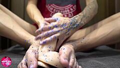 Watch this babe give a sensual footjob to a rubber cock.