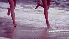 Four beautiful girls nude on the beach enjoying the sun