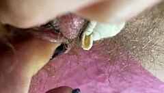 Close up of a big and sensitive clit rubbing to orgasm in a hairy wet vagina