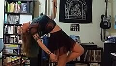 Blonde in black skirt strips teasingly