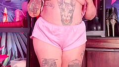 Teasing in silk pajamas with huge natural tits.