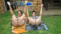 Half naked girls play with garden hose in kinky nature setting