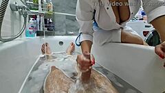 Stepmom walks in to wash her naked stepson, ignoring his excitement. She flashes big tits while he jerks off.