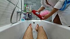 Stepmom walks in to wash her naked stepson, ignoring his excitement. She flashes big tits while he jerks off.