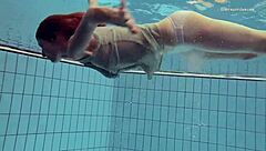 Nastya is a hot girl with a nice ass and she is wearing a dress while swimming in the pool