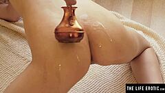 Petite teen oils up for close-up masturbation action