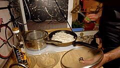 Naked gay chef cooks rice noodle with chicken and vegetables