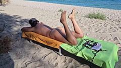 Beautiful naturist scenes of a brunette woman at a public beach