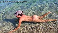 Beautiful naturist scenes of a brunette woman at a public beach