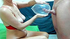 Beautiful woman with great sex drive with sperm-filled condom in bra and balloons