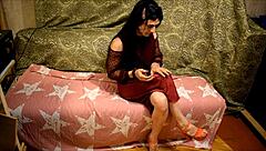 brunette shemale paints nails while showing off her legs