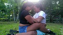 Hot lesbians kiss and caress outdoors in public park