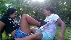 Hot lesbians kiss and caress outdoors in public park