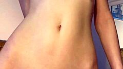 Petite teen 18+ reaches orgasm with dildo in tight pussy striptease solo session.