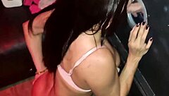 Brunette pornstar gives blowjob through glory hole at party