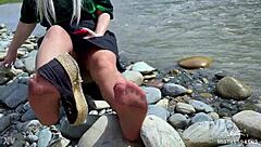 Cute MILF teasing in tan nylons on the riverbank