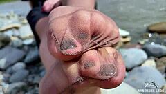 Goddess In Tan Nylons Shows Cute Nylon Soles And Toes On The Riverside