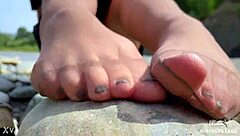 Goddess In Tan Nylons Shows Cute Nylon Soles And Toes On The Riverside