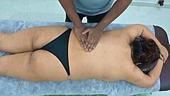 A curvaceous Latina gets a sensual massage from a dark-skinned Indian man