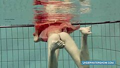 Katya feels free in red dress at pool.