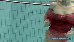 Katya feels free in red dress at pool.