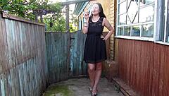 Watch the curvy milf smoking outdoors